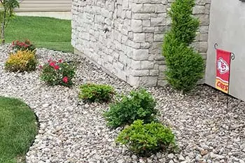 New rock mulch laid in landscape bed at Columbia home.
